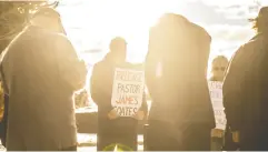  ?? JASON FRANSON / THE CANADIAN PRESS ?? Supporters pray as pastor James Coates of Gracelife Church was in court in Stony Plain, Alta., this week.