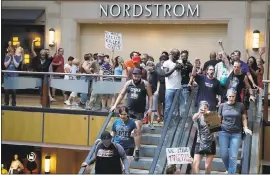  ?? JEFF ROBERSON — THE ASSOCIATED PRESS ?? Protesters march through West County Mall in response to a not guilty verdict in the trial of former St. Louis police officer Jason Stockley Saturday in Des Peres, Mo. Stockley was acquitted on Friday in the 2011killin­g of Anthony Lamar Smith, a black...