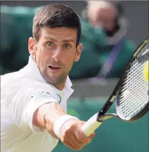  ?? Kirsty Wiggleswor­th / Associated Press ?? Novak Djokovic plays a return to Matteo Berrettini during the men’s singles final at Wimbledon in July.