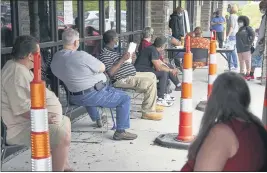  ?? NATI HARNIK — THE ASSOCIATED PRESS ?? Job seekers maintain social distancing as they wait to be called into the Heartland Workforce Solutions office in Omaha, Neb., in July.