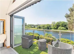  ?? ?? RIVER VIEWS: Large windows mean light floods into the spacious rooms of this riverside home, while the two balconies and stepped garden make the most of the Dee views.