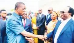  ?? ?? FORMER President Edgar Lungu (left) greets Brian Mundubile, the Leader of Opposition in Parliament at the Liberty Life Assembly Church in Meanwood Ndeke in yesterday where he attended Easter Sunday Church service