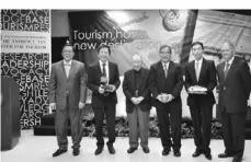  ??  ?? Standing from left are Jesli A. Lapus, member of the Asian Institute of Management Board of Trustees; Dr. Andrew L. Tan, Chairman of Alliance Global Group; Washington Z. Sycip, Chairman Emeritus of the AIM Board of Governors; Tourism Secretary Ramon R....