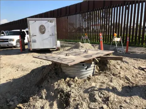  ?? Eliot Spagat/Associated Press ?? A covered access point leads to the longest smuggling tunnel ever found on the U.S. side of the border wall Wednesday in San Diego. U.S. Customs and Border Protection said the tunnel stretches more than three-quarters of a mile from a small warehouse in Tijuana, Mexico, into the San Diego area.