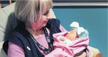  ?? DAN JANISSE ?? Volunteer Diana Learn holds healthy four-day-old baby Evelin at the Windsor Regional Hospital Met Campus on Wednesday. Learn will be taking on a new role as a cuddler with the NICU. The volunteers, with the parents’ consent, will cuddle with a newborn...