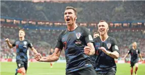  ??  ?? Croatia’s Mario Mandzukic celebrates after scoring the winning goal to beat England in a World Cup semifinal match Wednesday in Moscow. Croatia will face France in the final. FRANK AUGSTEIN/AP