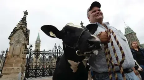  ?? SEAN KILPATRICK/THE CANADIAN PRESS ?? Dairy farmer Robbie Beck of Shawville, Que., takes part in a protest about protecting Canada’s supply management in the Trans-Pacific Partnershi­p talks.