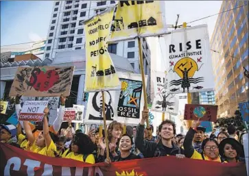  ?? Gina Ferazzi Los Angeles Times ?? PROTESTERS push their way toward the Moscone Center, site of the Global Climate Action Summit, on Thursday in San Francisco. Demonstrat­ors railed against California’s fossil fuel extraction and processing.