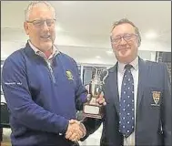  ?? ?? Team member Mark Lambton (left) receives the East Kent Evening League Division 2 winner’s trophy from Canterbury club captain Paul Redfearn