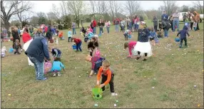  ?? Westside Eagle Observer/SUSAN HOLLAND ?? Youngsters in the 6-8 age group gather eggs at one of the Easter egg hunts during Saturday’s Easter Eggstravag­anza at Ozarks Community Hospital.