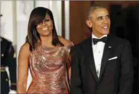  ?? PABLO MARTINEZ MONSIVAIS — THE ASSOCIATED PRESS FILE ?? In this file photo, President Barack Obama and first lady Michelle Obama wait to greet Italian Prime Minister Matteo Renzi and his wife Agnese Landini for a State Dinner at the White House in Washington.