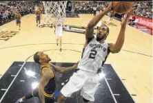  ?? Edward A. Ornelas / San Antonio Express-News ?? San Antonio’s Kawhi Leonard, who has double-figure scoring in 100 consecutiv­e games, shoots around the Cavs’ J.R. Smith.