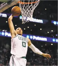  ?? Maddie Meyer / Getty Images ?? Boston’s Jayson Tatum, the No. 3 pick in last year’s draft, dunks for two of his personal-high 28 points against the 76ers.