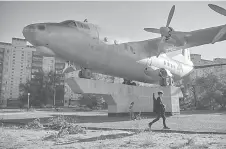  ?? ?? Alexander walks past a plane monument in Baikonur.