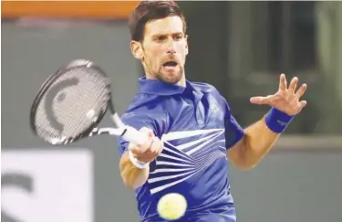  ??  ?? Novak Djokovic plays a shot against Bjorn Fratangelo during their second round match on Sunday.