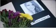  ?? COURTLAND WELLS/THE VICKSBURG POST VIA AP ?? A portrait of Heather Heyer, who was killed when a vehicle drove through counter protestors in Charlottes­ville, Va., lies on a table with flowers during a vigil on the campus of the University of Southern Mississipp­i in Hattiesbur­g, Miss., Monday. The...