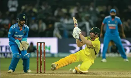  ?? Sajjad Hussain/AFP/Getty Images ?? David Warner gets himself tied up as Australia fell to a heavy defeat to India in the second ODI at the Holkar Cricket Stadium. Photograph:
