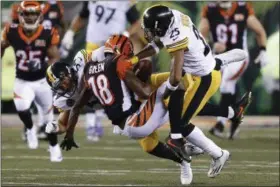  ?? GARY LANDERS — THE ASSOCIATED PRESS ?? Bengals wide receiver A.J. Green is tackled by Steelers linebacker L.J. Fort (54) and cornerback Artie Burns (25) in the second half of a Dec. 4 game in Cincinnati.