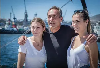  ??  ?? Mike with his daughters Jessica and Annika on 18 November 2016, before he set off on the journey from Cape Town to Antarctica for his 57-day solo expedition.