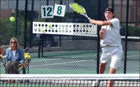  ?? Photos by LARRY GREESON / For the Calhoun Times ?? ( Calhoun’s Hunter Hartsfield sends a return back over the net during his No. 1 doubles match on Wednesday. ( Calhoun’s Matthew McCanless serves during his No. 3 singles match against North Hall.