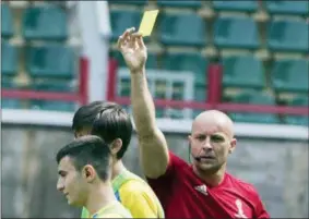  ?? PAVEL GOLOVKIN — THE ASSOCIATED PRESS ?? Referee Szymon Marciniak of Poland shows a yellow card during a training session in Moscow, Russia, Tuesday. The 21st World Cup begins on Thursday when host Russia takes on Saudi Arabia.
