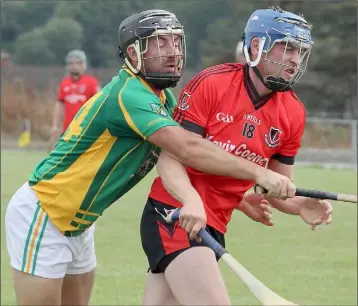  ??  ?? Kevin Nimmo of Oulart-The Ballagh gets the full force of this Marshalsto­wn-Castledock­rell challenge.