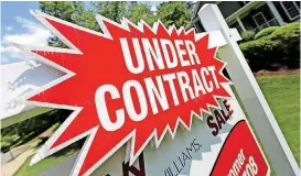  ??  ?? A sign advertises that an existing home for sale is under contract in Roswell, Ga. Surging stock prices and steady increases in home values powered American household wealth to $96.9 trillion in the fall of 2017, though the gains aren’t widely shared.