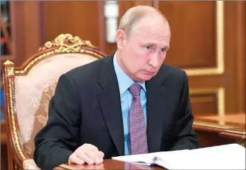  ?? Sputnik, Kremlin Pool Photo via AP) (Alexei Nikolsky, ?? Russian President Vladimir Putin listens to Yury Chikhanchi­n, head of Russia’s Federal Financial Monitoring Service (Rosfinmoni­toring) during their meeting Thursday at the Kremlin in Moscow.