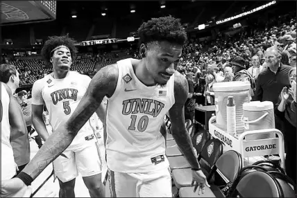  ?? STEVE MARCUS ?? UNLV forwards Rob Whaley Jr. (5) and Kalib Boone (10) leave the court Sunday after the Runnin’ Rebels defeated Boston College, 79-70, in the second round of the National Invitation Tournament at the Thomas & Mack Center. UNLV travels to South Orange, N.J., to face Seton Hall today in the quarterfin­als of the NIT.