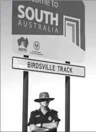  ?? SAEED KHAN / AFP ?? Senior Constable Stephan Pursell watches traffic on the remote Queensland border outside Birdsville on Aug 30.