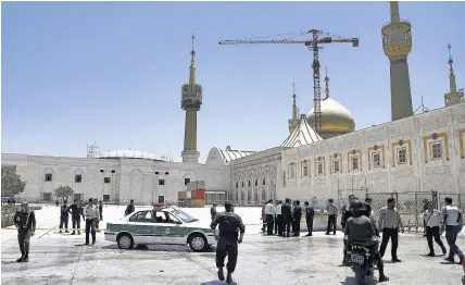  ??  ?? > Police officers control the scene around the shrine of late Iranian revolution­ary founder Ayatollah Khomeini, after an assault by several attackers just outside Tehran, Iran, yesterday