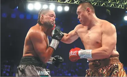  ?? DAZN BOXING ?? Chinese heavyweigh­t Zhang Zhilei (right) lands a right hook on Joe Joyce during his knockout win over the Briton in their rematch at Wembley Arena in London on Sept 23, 2023.