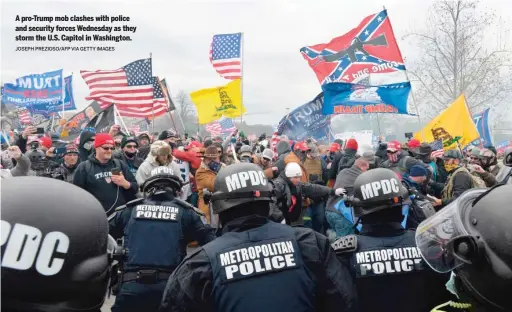  ?? JOSEPH PREZIOSO/ AFP VIA GETTY IMAGES ?? A pro- Trump mob clashes with police and security forces Wednesday as they storm the U. S. Capitol in Washington.