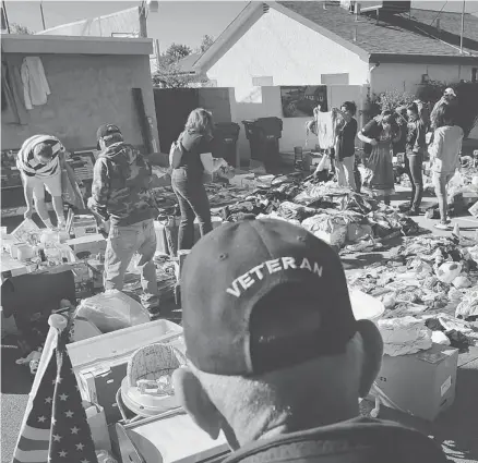  ?? Photos: Jae C. Hong/The Associated Press ?? A Vietnam War veteran watches people shop at a yard sale held to benefit paralyzed Iraq war veteran Jerral Hancock, in Lancaster, Calif.