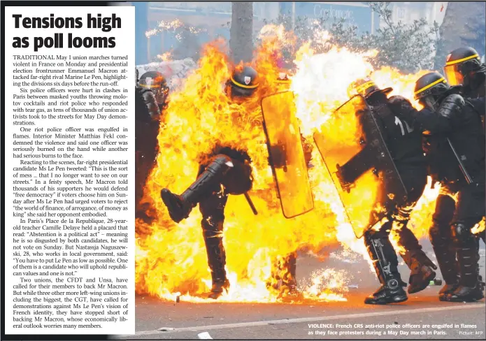  ?? Picture: AFP ?? VIOLENCE: French CRS anti- riot police officers are engulfed in flames as they face protesters during a May Day march in Paris.