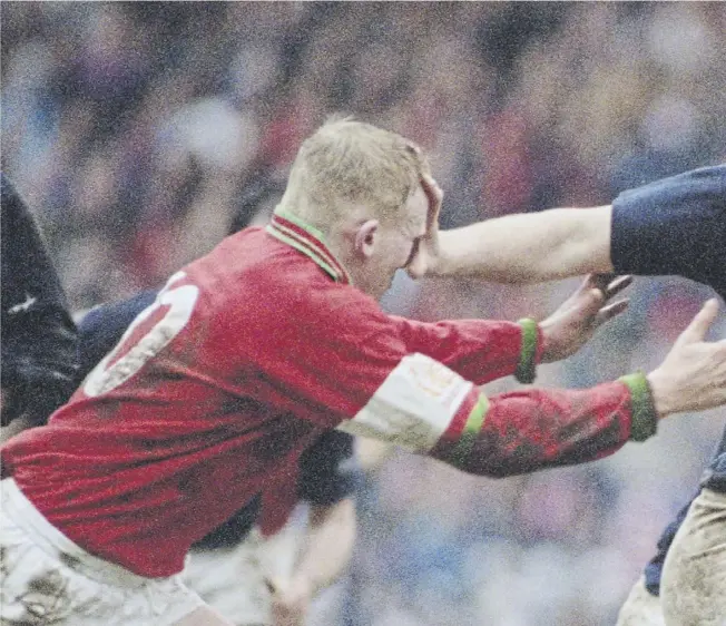  ?? ?? ↑ Legendary forward Doddie Weir hands off Neil Jenkins of Wales during a Five Nations Championsh­ip match at Murrayfiel­d in March 1995. Scotland won the match 26-13.