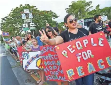  ?? FRANK SAN NICOLAS, PACIFIC (GUAM) DAILY NEWS ?? Guam residents staged a “People for Peace” rally in Hagåtña on Monday amid the North Korean missile crisis.