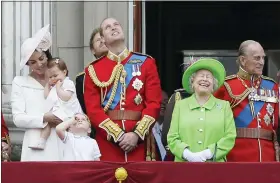  ?? TIM IRELAND — THE ASSOCIATED PRESS FILE ?? Queen Elizabeth II wears a bright green outfit as she appears with Prince Philip, right, Prince William, center, his son Prince George, front, and Kate, Duchess of Cambridge holding Princess Charlotte, left, on the balcony during the Trooping The Colour parade at Buckingham Palace, in London, on June 11, 2016.