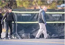  ?? MARLA BROSE/ JOURNAL ?? Officers set up a curtain around a body found on Edith just south of Lomas NE early Wednesday.