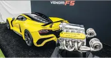  ?? HENNESSEY ?? The Hennessey Venom F5 hypercar on display beside the vehicle’s monstrous 1,600-horsepower V-8 engine.