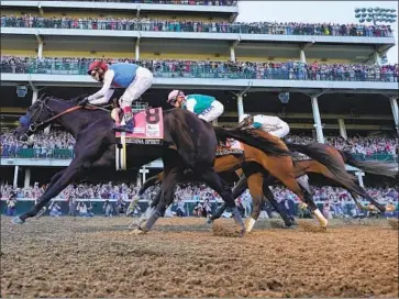  ?? Jeff Roberson Associated Press ?? MEDINA SPIRIT, ridden by John Velazquez and leading Florent Geroux on Mandaloun and Flavien Prat on Hot Rod Charlie, is on his way to winning the 147th running of the Kentucky Derby at Churchill Downs.