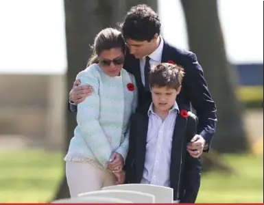  ?? AFP/GETTY IMAGES ?? Prime Minister Justin Trudeau, his wife Sophie Grégoire Trudeau and their son Xavier at the gravesite of one of Grégoire Trudeau’s relatives, who was killed during World War II, in France on Monday.