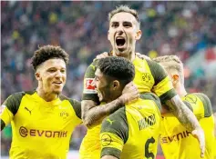  ??  ?? Dortmund’s forward Paco Alcacer (top, centre) celebrates with his teammates midfielder Jadon Sancho (left) and defender Achraf Hakimi (centre, bottom) after scoring the 2-3 during the German Bundesliga match of against Bayer Leverkusen in Leverkusen, western Germany in this Sept 29 file photo. — AFP photo