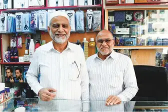  ?? Abdul Rahman/Gulf News ?? Mohammad Jaafar (left) and Mohammad Rizwan have been running their gift shop selling cosmetics, garments and electronic­s near Hamdan Street in Abu Dhabi since 1972.