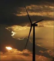  ?? CHARLIE RIEDEL — THE ASSOCIATED PRESS FILE PHOTO ?? A wind turbine, part of the Lost Creek Wind Farm, is silhouette­d against the setting sun near King City, Mo.