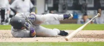  ??  ?? Rockies outfielder Gerardo Parra falls after being hit by a pitch during the eighth inning of Sunday’s series finale against the Padres in San Diego. Parra is batting .308 this year. Denis Poroy, Getty Images