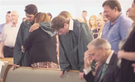  ?? COURTNEY SACCO/USA TODAY NETWORK ?? Santa Fe High School students join mourners at the city’s Arcadia First Baptist Church on Sunday, two days after 10 people at the school were killed. “We have fallen away from God,” the pastor told the congregati­on.