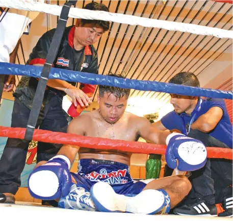  ??  ?? Cornermen of Jomyuth Sor Narongchai come to his aid after he was stopped in the fourth round by Sebastian ‘The Sniper’ Singh at the Novotel Suva Lami Bay Convention Centre on February 16, 2018. Photo:Ronald Kumar