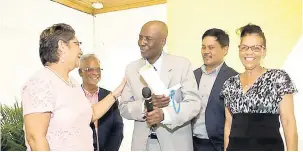  ??  ?? Clinton Wilson (centre), recipient of the JGRA Lifetime Achievemen­t Award, is being congratula­ted by (from left) Sandra Kenny, Trevor Heaven, Gregory Chung, chairman of the JGRA, and Leanora Wilson.