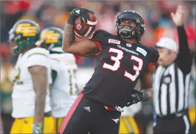  ?? The Canadian Press ?? Calgary Stampeders running back Jerome Messam (33) celebrates his two-point conversion in front of the Edmonton Eskimos during second-quarter CFL playoff action in Calgary on Sunday. The Stampeders won the West Division final 32-28.